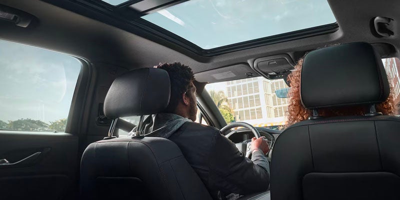 Guy driving a car holding the steering wheel
