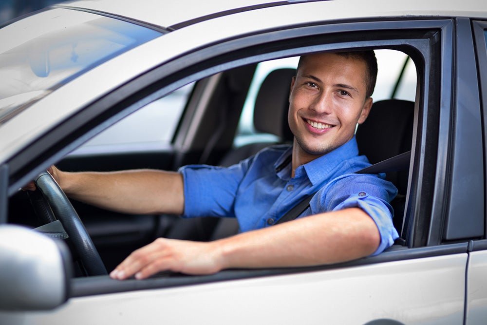 Man Smiling out car window